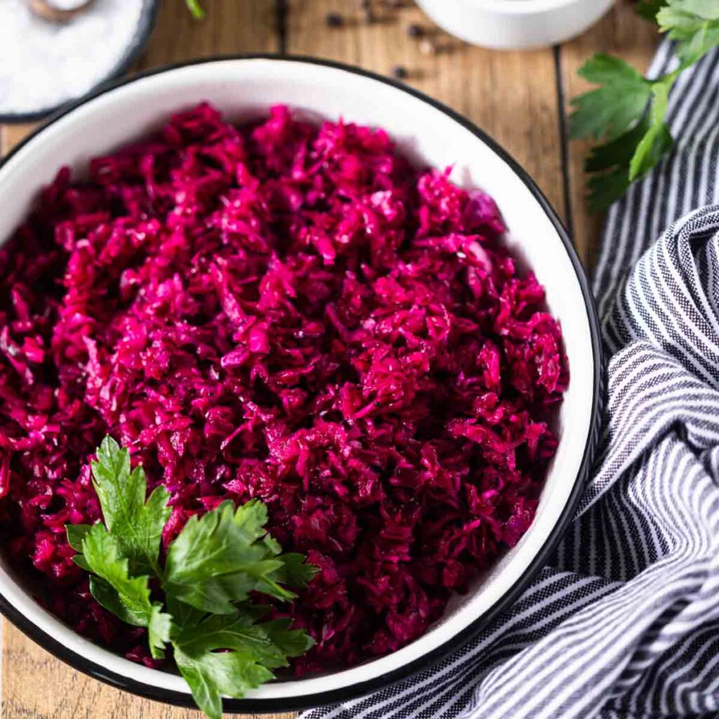 German Red Cabbage Salad in a bowl garnished with parsley