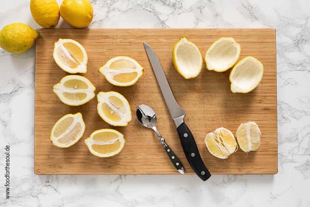 Zitronen halbieren und Fruchtfleisch auskratzen für Lemon Posset Dessert - Schritt 2