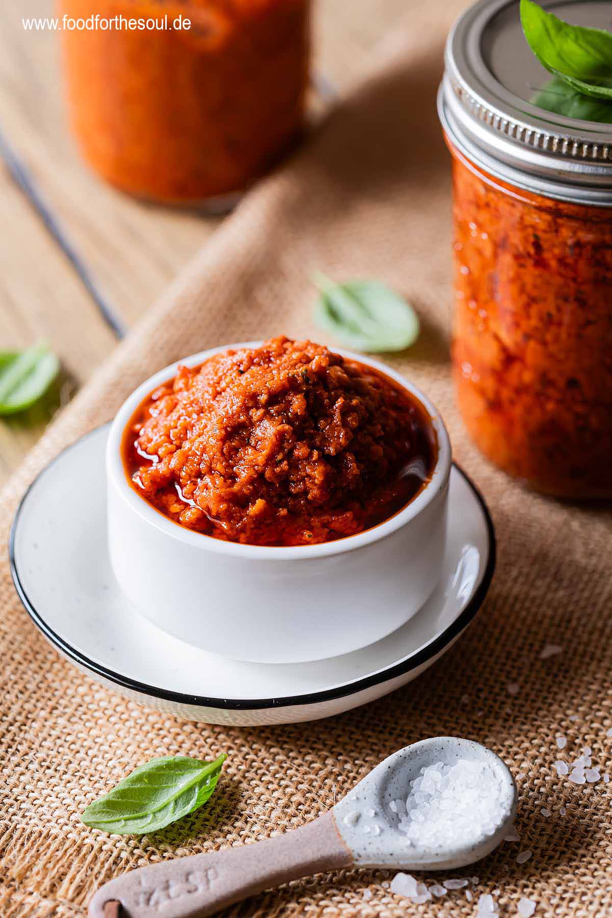 Selbstgemachtes Tomatenpesto in einer Schale und Gläsern