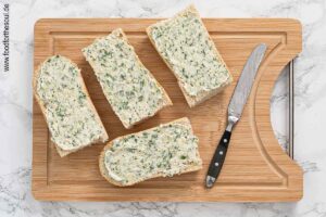Baguette halbieren und vierteln, mit Knoblauchbutter bestreichen - Schritt 4