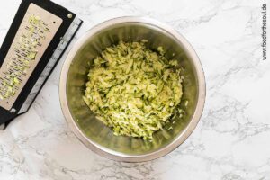 Zucchini waschen, Enden entfernen und raspeln - Schritt 5